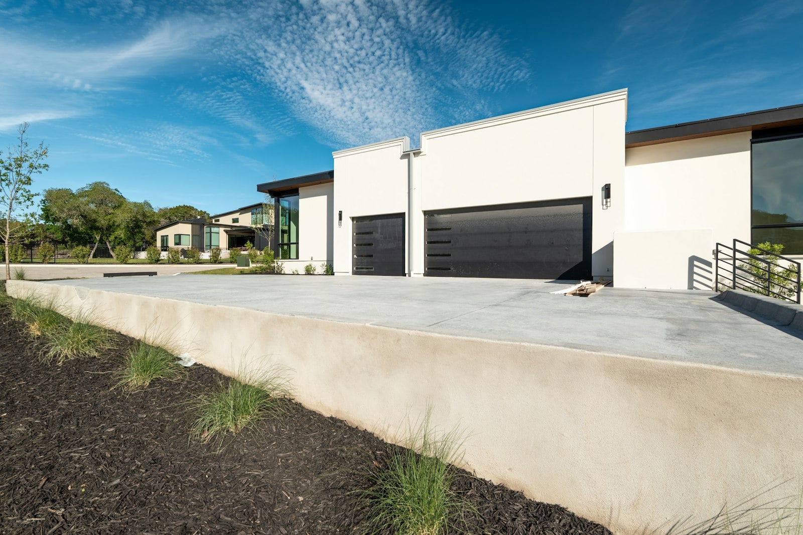 Modern house with black sectional garage doors