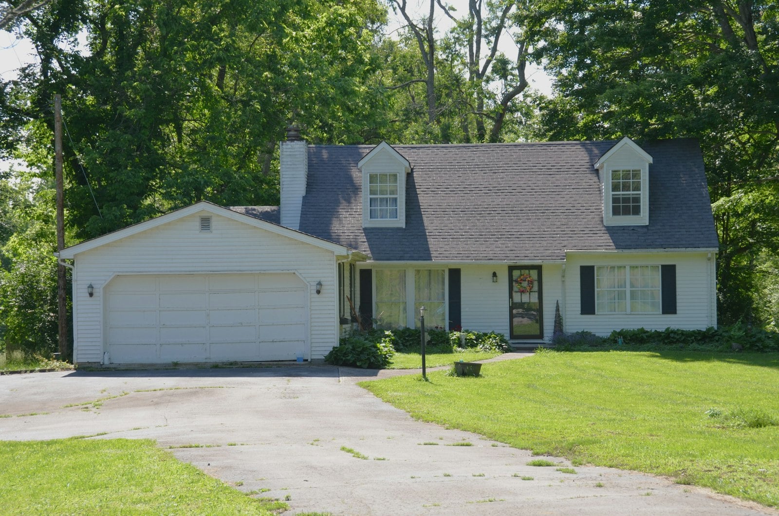 Two-car garage door on a white suburban house